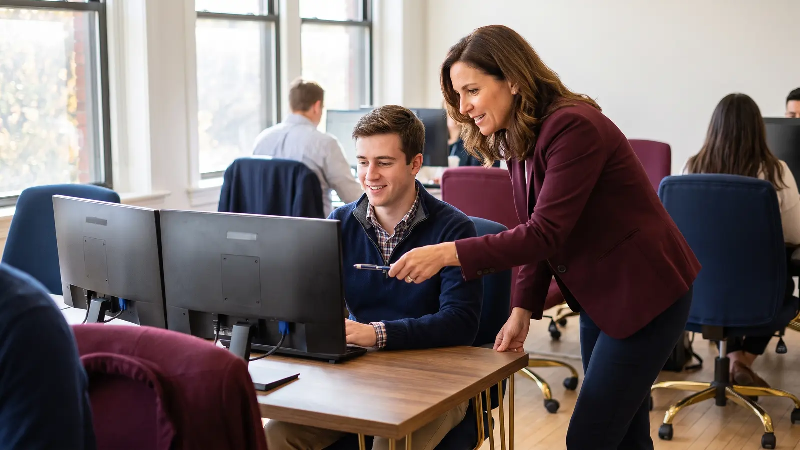 New freight agent at his desk on his first day as a brokerage manager shows him around